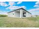 Side view of house showcasing covered patio and yard at 384 Baytree Dr, Rotonda West, FL 33947