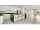 Modern kitchen with white cabinets, black countertops, and stainless steel appliances at 384 Baytree Dr, Rotonda West, FL 33947