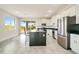 Modern kitchen with white cabinets, black countertops, and stainless steel appliances at 384 Baytree Dr, Rotonda West, FL 33947