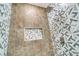 Modern shower with geometric patterned tile and built-in shelf at 384 Baytree Dr, Rotonda West, FL 33947