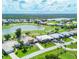 Beautiful aerial shot showcases a residential neighborhood with lake and golf course views and lush landscapes at 4663 Arlington Dr, Placida, FL 33946