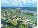 Stunning aerial view of a waterfront community surrounded by canals, a lake, and a golf course at 4663 Arlington Dr, Placida, FL 33946