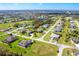 Aerial view of a home in a peaceful neighborhood with beautiful houses and green spaces at 65 Par View Ter, Rotonda West, FL 33947