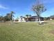 Spacious backyard with lush lawn and mature trees at 78 Lima St, Punta Gorda, FL 33983