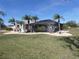 Landscaped backyard with tropical plants surrounding the home at 78 Lima St, Punta Gorda, FL 33983