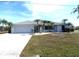 Single story home with attached garage and manicured lawn at 78 Lima St, Punta Gorda, FL 33983