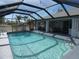 Refreshing screened pool with a spacious deck and string lights at 78 Lima St, Punta Gorda, FL 33983