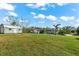 Large grassy backyard with shed and boat in the background at 15576 Aldama Cir, Port Charlotte, FL 33981