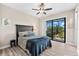Primary bedroom with a king bed, ceiling fan and access to patio at 15576 Aldama Cir, Port Charlotte, FL 33981