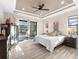 Bright bedroom with king-size bed, sliding doors to patio, and large windows at 15576 Aldama Cir, Port Charlotte, FL 33981