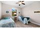 Guest bedroom with twin beds, ceiling fan and natural light at 15576 Aldama Cir, Port Charlotte, FL 33981