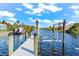 Private boat dock with lift on a tranquil canal at 15576 Aldama Cir, Port Charlotte, FL 33981