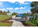 Serene canal view with patio seating and boat dock at 15576 Aldama Cir, Port Charlotte, FL 33981