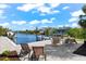 Spacious canal-side patio with seating and fire pit at 15576 Aldama Cir, Port Charlotte, FL 33981
