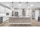 Modern kitchen with white cabinets, granite island, and stainless steel appliances at 15576 Aldama Cir, Port Charlotte, FL 33981