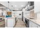 Modern kitchen with white cabinets, granite countertops, and stainless steel appliances at 15576 Aldama Cir, Port Charlotte, FL 33981