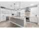 Modern kitchen with white cabinets, granite countertops, and stainless steel appliances at 15576 Aldama Cir, Port Charlotte, FL 33981