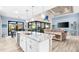Open concept kitchen with island, stainless steel appliances, and views to the pool at 15576 Aldama Cir, Port Charlotte, FL 33981