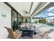 Covered lanai with seating area and view of the pool at 15576 Aldama Cir, Port Charlotte, FL 33981