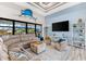 Spacious living area with large sectional sofa, high ceilings, and water views at 15576 Aldama Cir, Port Charlotte, FL 33981