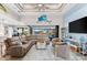 Spacious living area with large sectional sofa, high ceilings, and water views at 15576 Aldama Cir, Port Charlotte, FL 33981