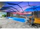 Lighted pool and spa with covered patio and sunset view at 15576 Aldama Cir, Port Charlotte, FL 33981