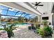 Covered patio with pool, spa and plenty of plants at 15576 Aldama Cir, Port Charlotte, FL 33981