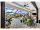Relaxing pool and patio area with covered lanai and lush landscaping at 15576 Aldama Cir, Port Charlotte, FL 33981