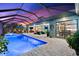 Lighted pool and spa with covered patio and interior view at 15576 Aldama Cir, Port Charlotte, FL 33981