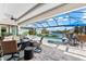 Stunning pool and lanai with patio furniture and water view at 15576 Aldama Cir, Port Charlotte, FL 33981