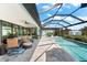 Spacious lanai, pool, and patio furniture at 15576 Aldama Cir, Port Charlotte, FL 33981
