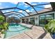 Resort-style pool and lanai with covered seating at 15576 Aldama Cir, Port Charlotte, FL 33981