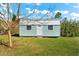Light teal storage shed with metal roof and white door at 15576 Aldama Cir, Port Charlotte, FL 33981