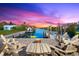 Relaxing waterfront patio with fire pit and seating area, perfect for enjoying sunsets at 15576 Aldama Cir, Port Charlotte, FL 33981