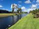 Beautiful view of a canal with lush green landscaping at 93 Fairway Rd, Rotonda West, FL 33947