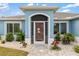 Charming light blue house with landscaped yard and three-car garage at 13838 Begonia Cir, Port Charlotte, FL 33981