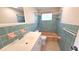 Bathroom with teal tile and a tub at 1446 Fairless Rd, Englewood, FL 34223