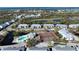 Aerial view of community with tennis courts, pool, and multiple buildings at 6800 Placida Rd # 268, Englewood, FL 34224