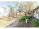 Landscaped backyard with brick pathway and lush greenery at 700 Coquina Ct, Nokomis, FL 34275