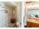 Updated bathroom with glass block shower and wood vanity at 700 Coquina Ct, Nokomis, FL 34275