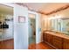 Bathroom with wood vanity, glass block shower, and walk-in closet at 700 Coquina Ct, Nokomis, FL 34275