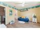 Bright bedroom with a daybed, built-in shelving, and access to a full bathroom at 700 Coquina Ct, Nokomis, FL 34275