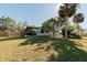 House exterior showcasing a hammock and lush landscaping at 700 Coquina Ct, Nokomis, FL 34275