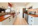 Updated kitchen featuring a copper farm sink and wood countertops at 700 Coquina Ct, Nokomis, FL 34275