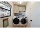 Laundry room with washer, dryer, and ample storage at 700 Coquina Ct, Nokomis, FL 34275