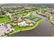 Aerial view of community amenities including pool, tennis courts, and clubhouse at 13215 Amerigo Ln, Venice, FL 34293