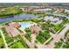 Aerial view of community amenities including pool, clubhouse, and palm trees at 13215 Amerigo Ln, Venice, FL 34293