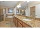 Elegant bathroom with granite countertops and soaking tub at 13215 Amerigo Ln, Venice, FL 34293