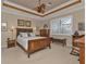 Spacious bedroom with wood furniture and water view at 13215 Amerigo Ln, Venice, FL 34293