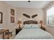 Serene bedroom with a queen bed and window with shutters at 13215 Amerigo Ln, Venice, FL 34293